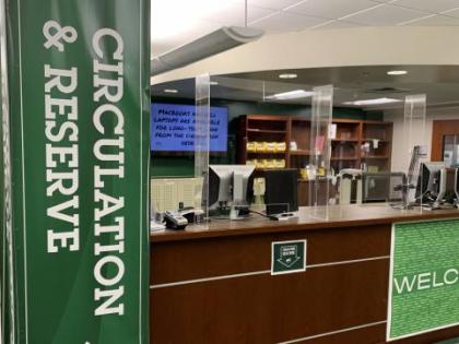 Image of the circulation desk with plexiglass guards installed